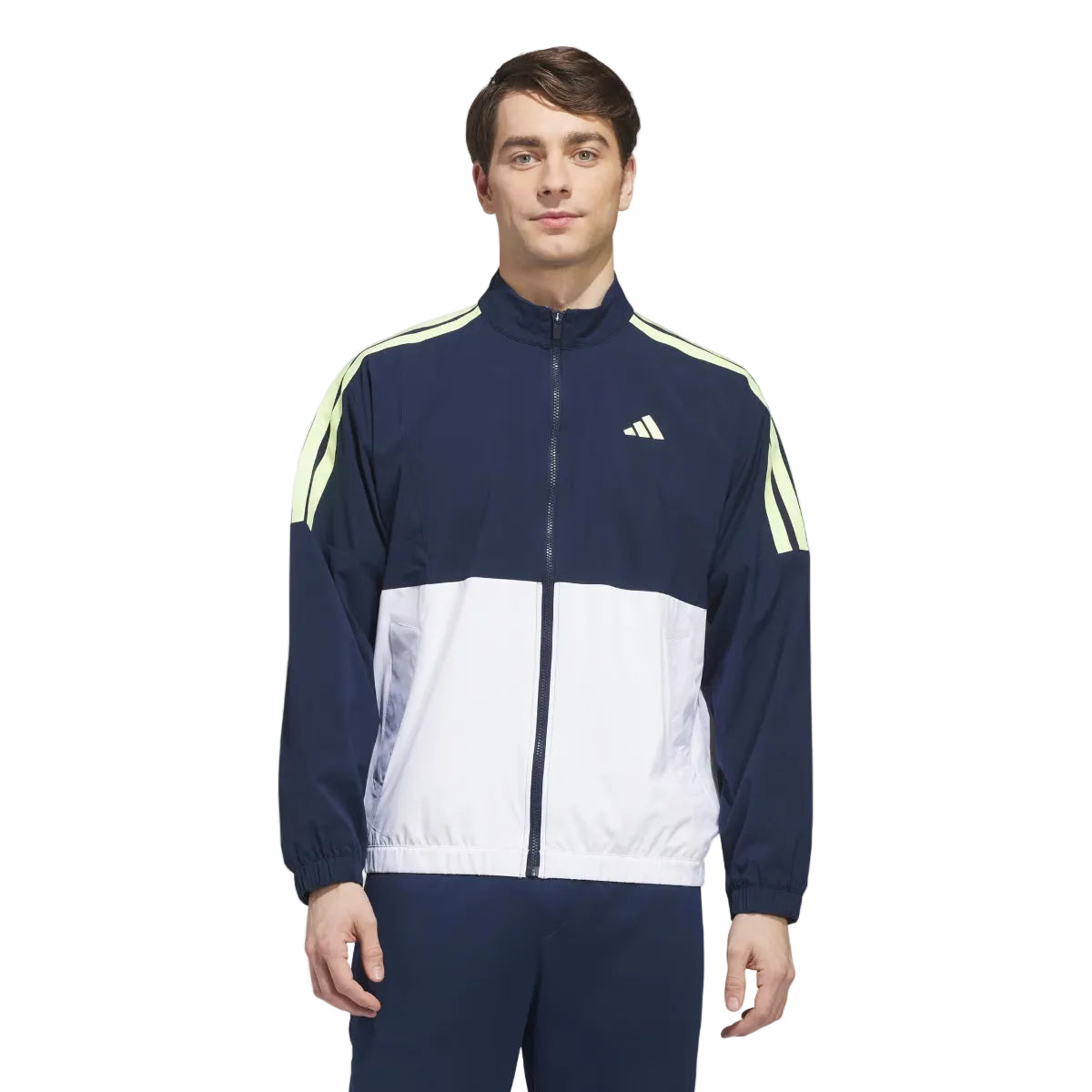 Person wearing a navy and white tracksuit with Adidas logo on a light gray background