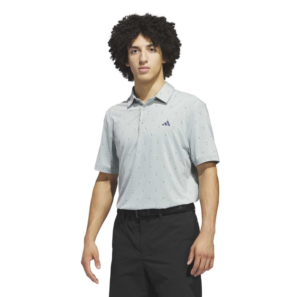 Light sage polo shirt with subtle pattern and Adidas logo on a white background