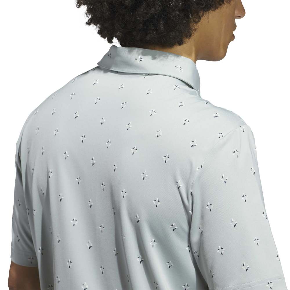 Light sage polo shirt with subtle pattern and Adidas logo on a white background