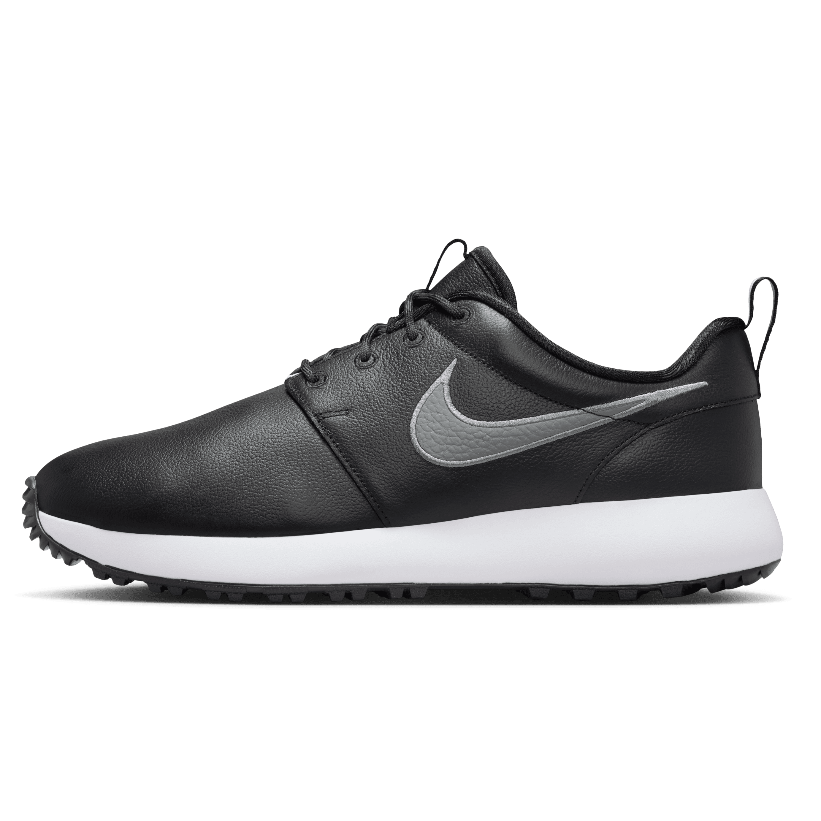 Black Nike shoe with a white sole on a dark gray background